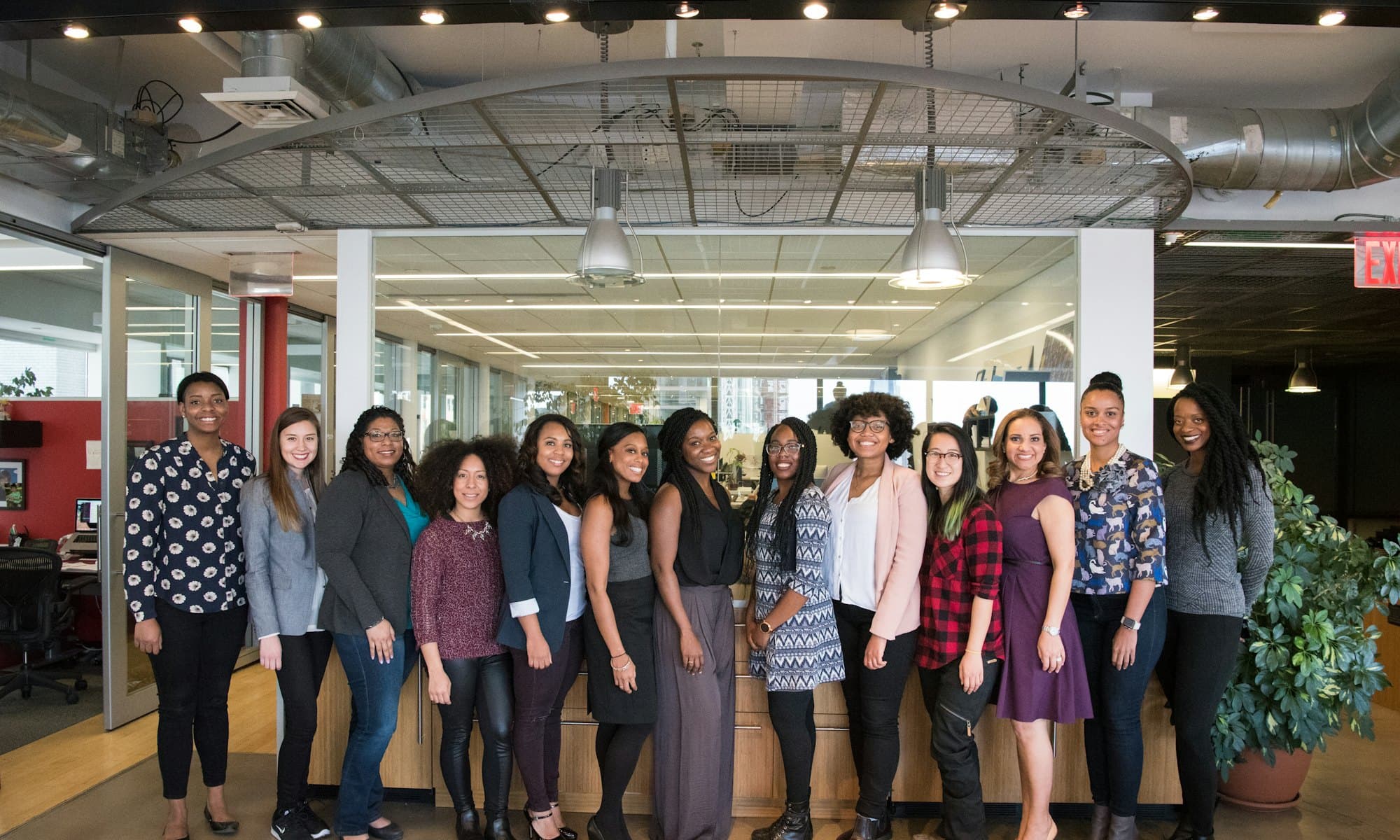 A workplace team standing together in their office
